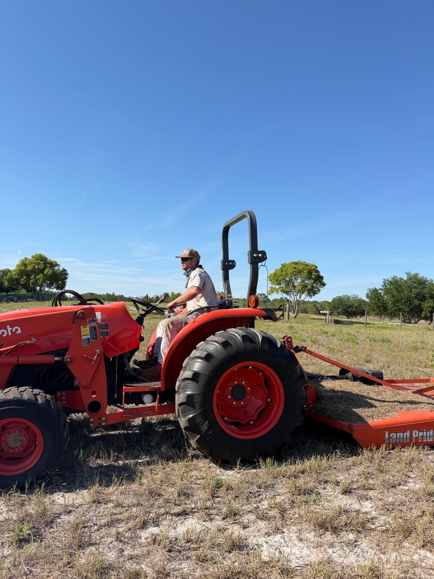 Hoag Land Services bush hogging a Central Florida hay field