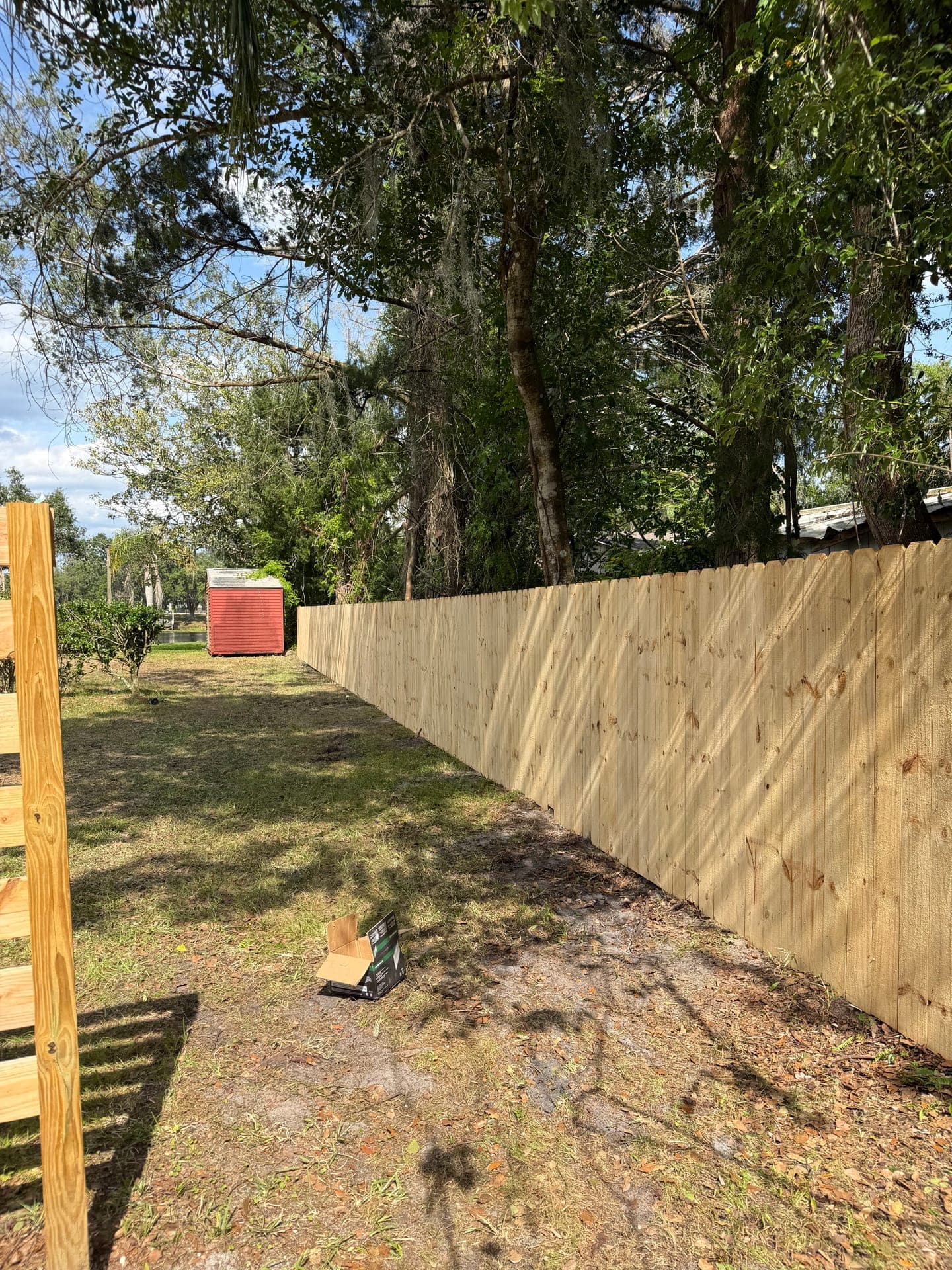 Fresh wood privacy fence installed at a Volusia County lake house by Hoag Land Services